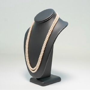 Double string long pearl necklace of fresh water pearls .